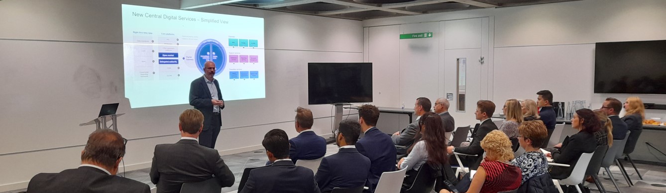 People sitting in a room watching the presentation during one of the sessions