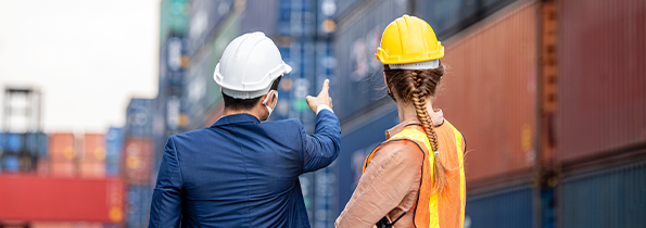 Workers at a ship yard with shipping containers