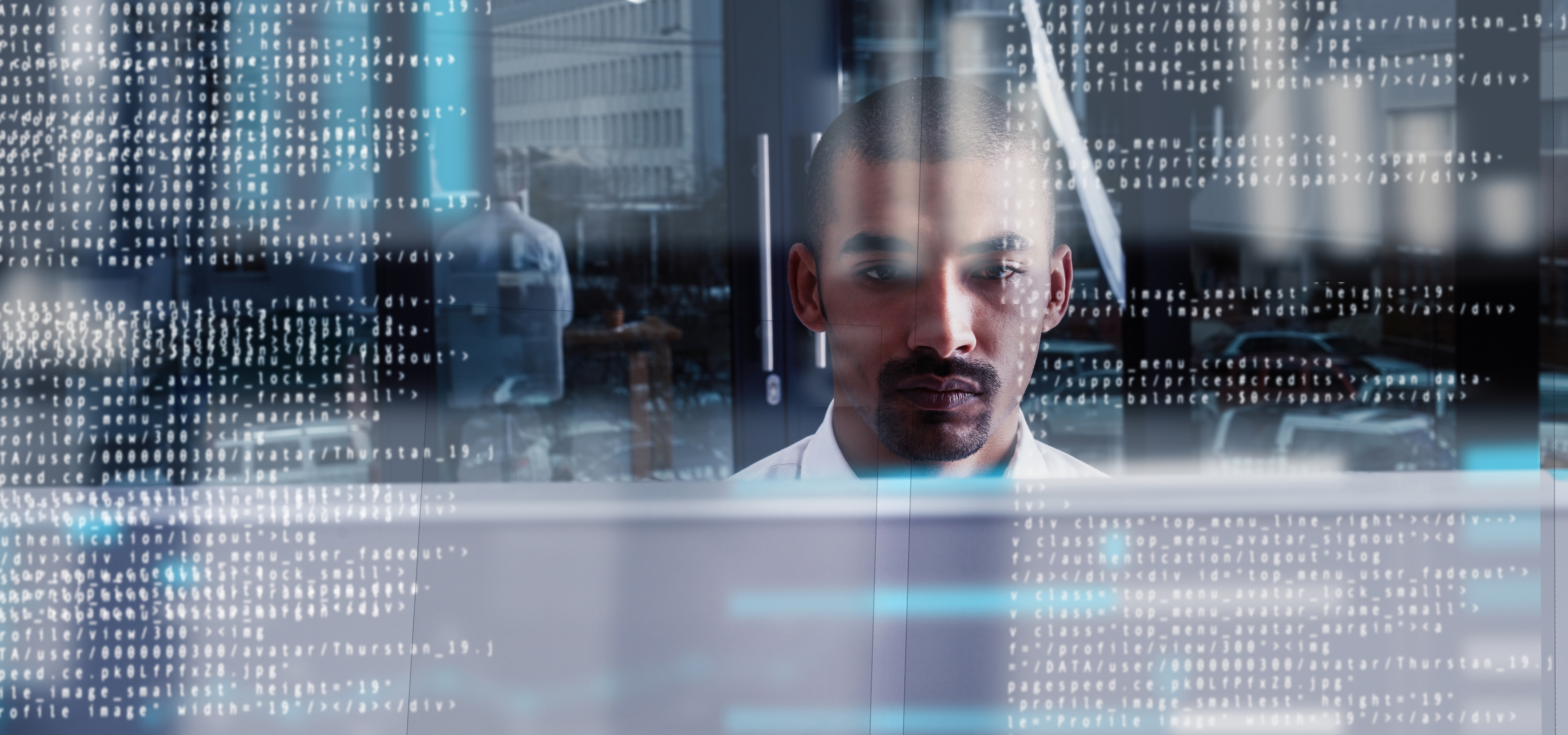 Reflection of a man in a computer screen