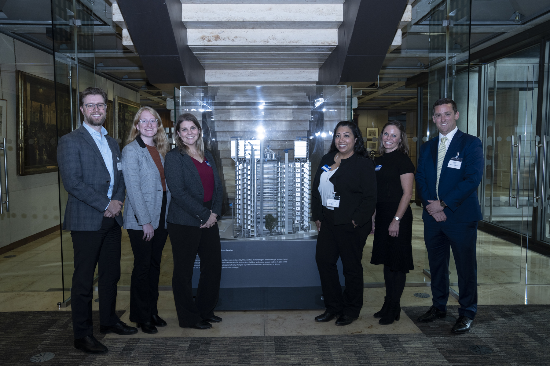 Delegates posing with the model of the Lloyd's building on G11