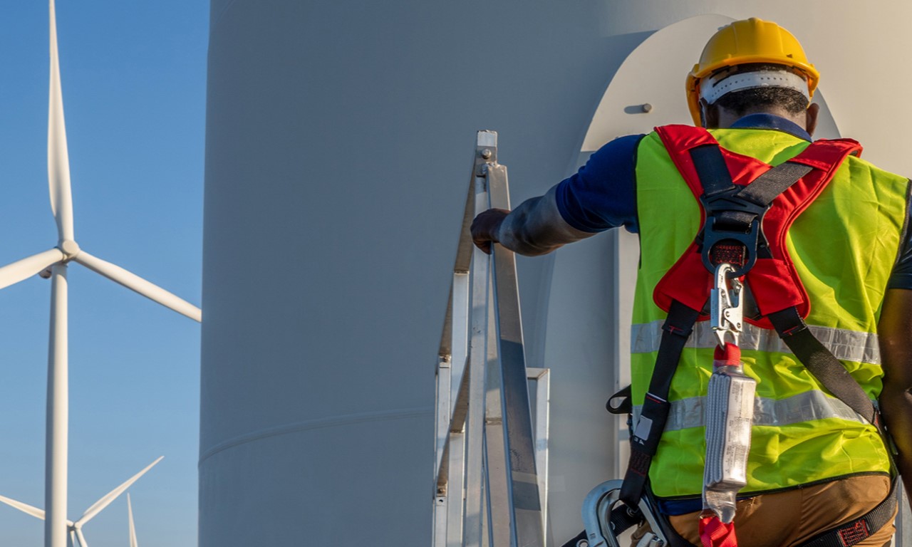 Worker overseeing wind turbine construction