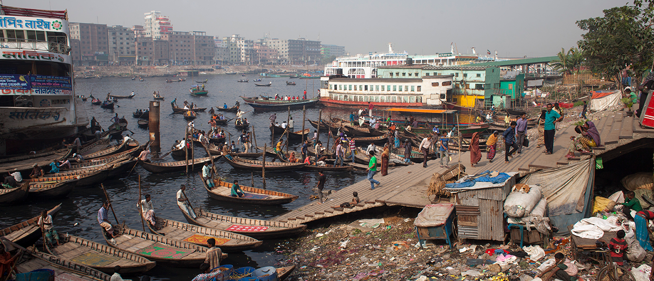 Boats and people on the side of a river in India