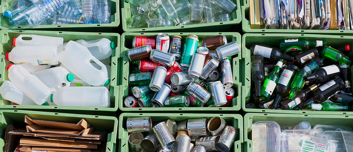 Bottles, cans and paper in recycling boxes