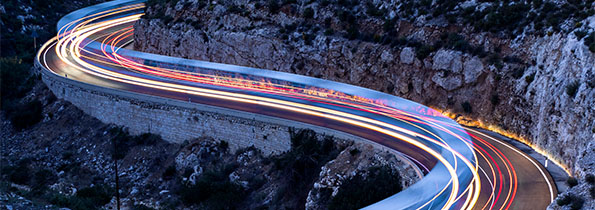 Long exposure of vehicles travelling on a mountain road